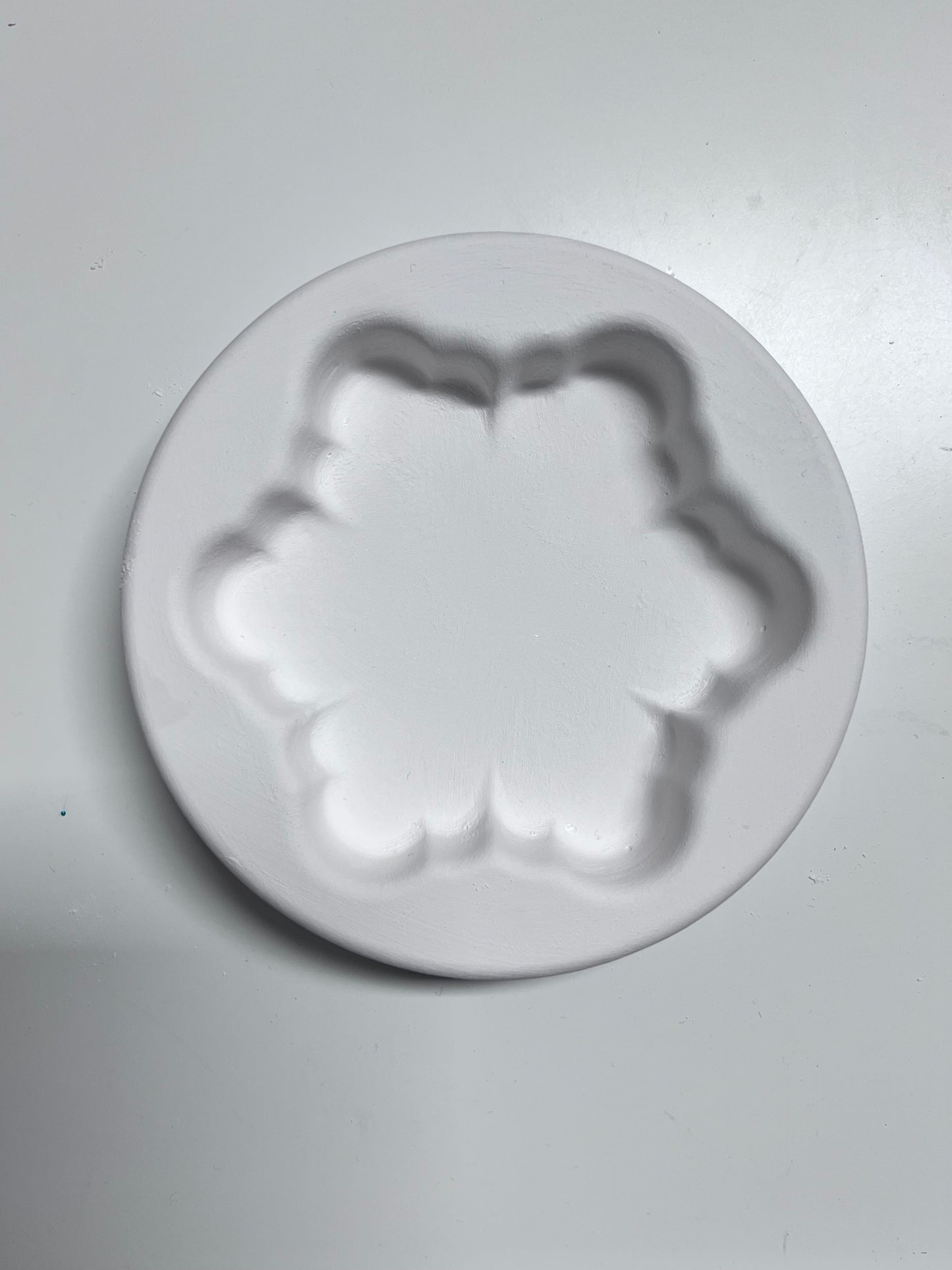 Photo of an empty solid snowflake fused glass casting mold, top view